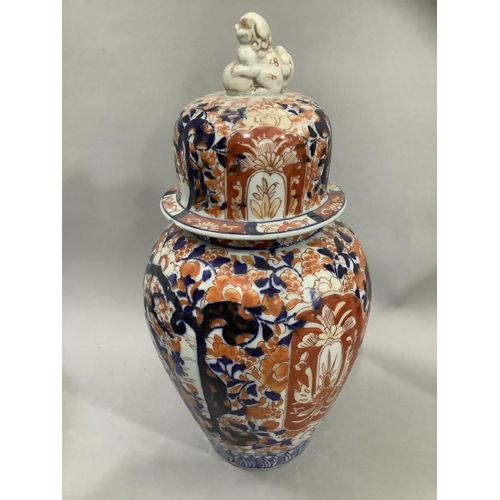 25 - A Japanese Imari vase and cover, the fluted body painted in the typical Imari palette, having a dome... 