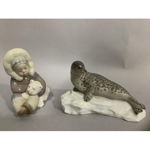 30 - A Lladro figure group of Inuit child and polar bear cub, 12cm high, together with a china figure of ... 