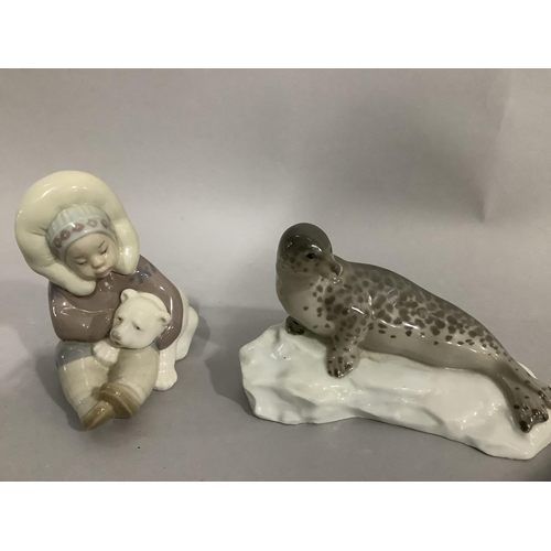 30 - A Lladro figure group of Inuit child and polar bear cub, 12cm high, together with a china figure of ... 