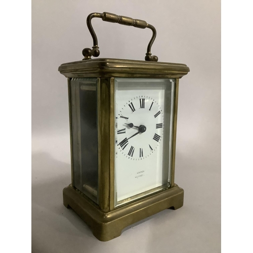 32 - A brass carriage clock by Snow and Ashworth of Harrogate with a French movement, white enamel dial w... 