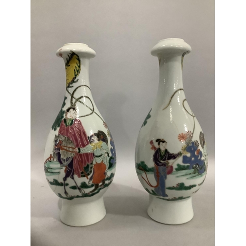 37 - A pair of Chinese famille rose vases, the bottle shaped bodies enamelled with merchantmen on horseba... 