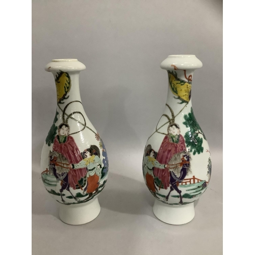 37 - A pair of Chinese famille rose vases, the bottle shaped bodies enamelled with merchantmen on horseba... 