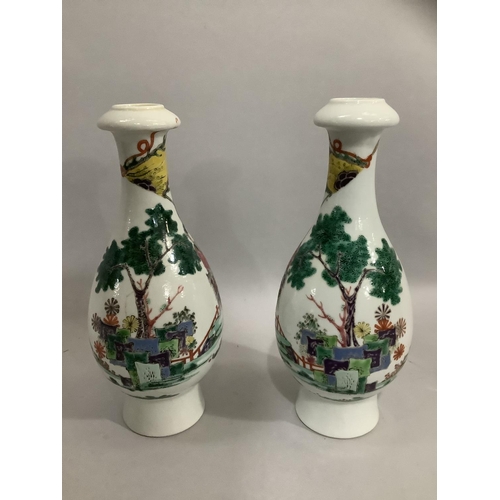 37 - A pair of Chinese famille rose vases, the bottle shaped bodies enamelled with merchantmen on horseba... 