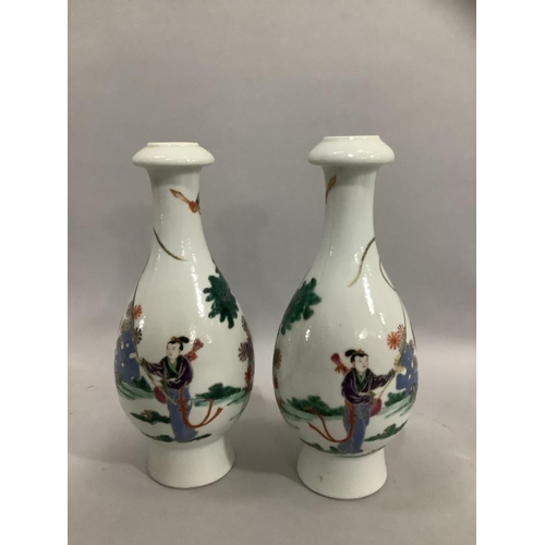 37 - A pair of Chinese famille rose vases, the bottle shaped bodies enamelled with merchantmen on horseba... 