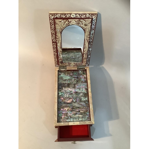 39 - A Chinese burgundy lacquered and mother-of-pearl casket, the lift up lid fitted with a mirror above ... 