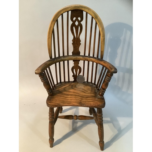 43 - An elm model of a high back Windsor armchair with H stretcher, 36.5cm high