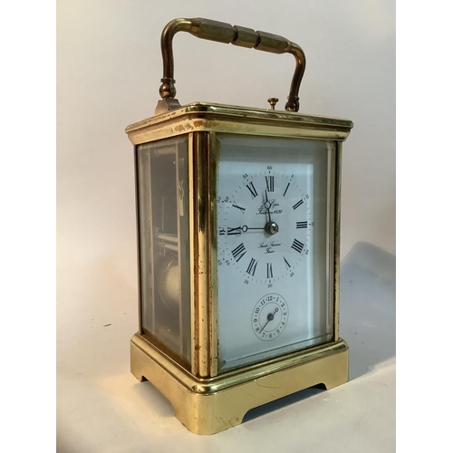 49 - A modern brass carriage clock with eight day repeat alarm movement, 18cm high over handle