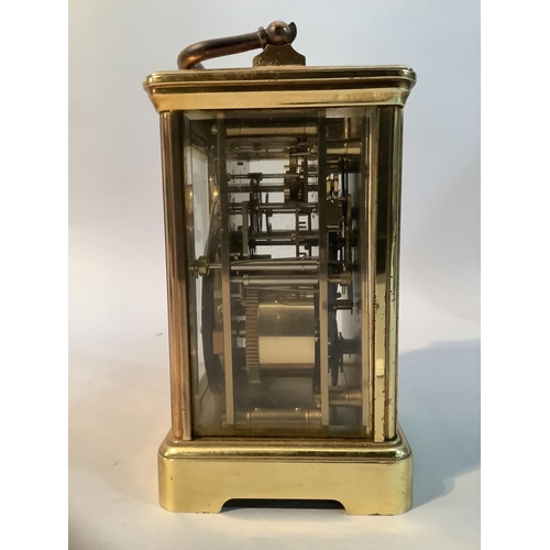 49 - A modern brass carriage clock with eight day repeat alarm movement, 18cm high over handle