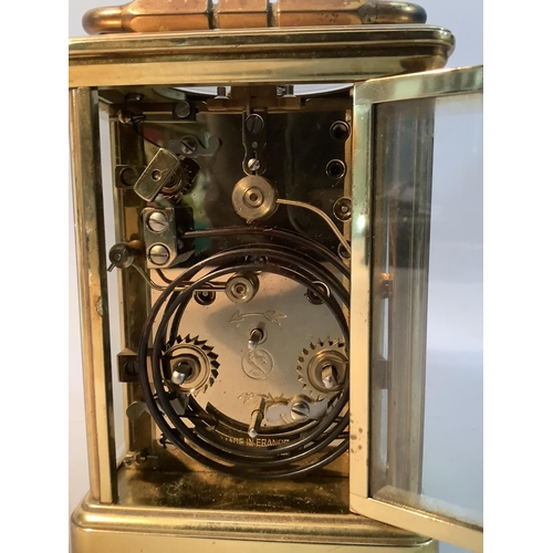 49 - A modern brass carriage clock with eight day repeat alarm movement, 18cm high over handle