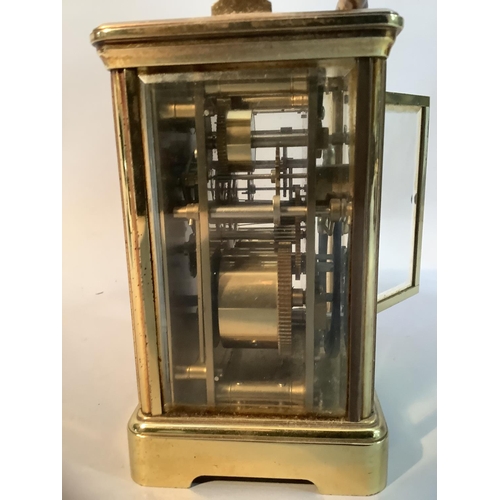 49 - A modern brass carriage clock with eight day repeat alarm movement, 18cm high over handle