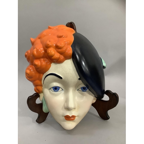 5 - A Beswick Art Deco pottery face mask of a girl wearing a black beret, printed mark and painted No: 7... 