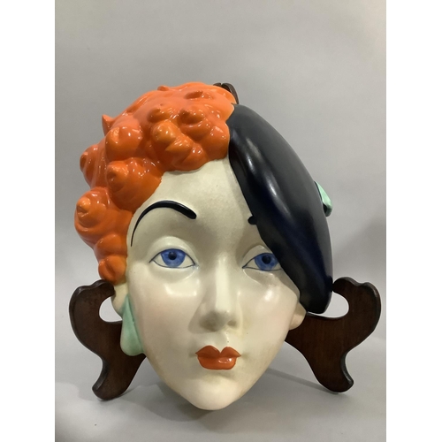 5 - A Beswick Art Deco pottery face mask of a girl wearing a black beret, printed mark and painted No: 7... 