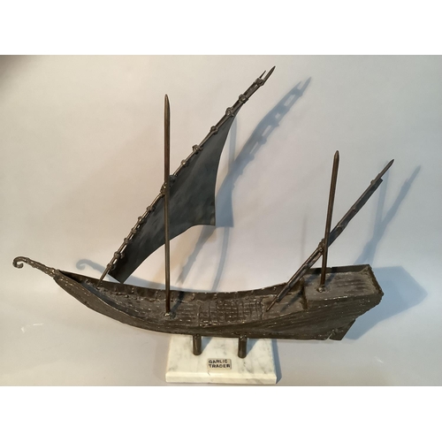 300 - F.J. Akers, sculpture of a cargo boat, in spelter on marble base, 46cm x 51cm