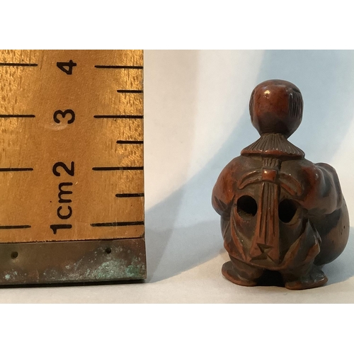 350 - A Japanese fruitwood netsuke carved as a man standing with his arms stretched around a large gourd, ... 