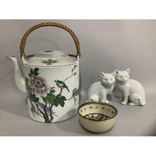 204 - Two Blanc de Chine porcelain figures of cats together with a Chinese teapot having a cylindrical bod... 