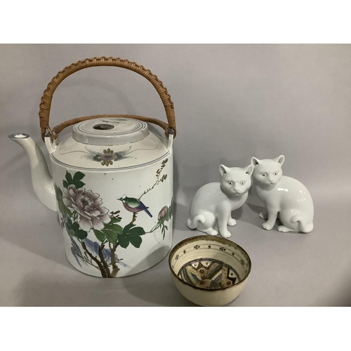 204 - Two Blanc de Chine porcelain figures of cats together with a Chinese teapot having a cylindrical bod... 