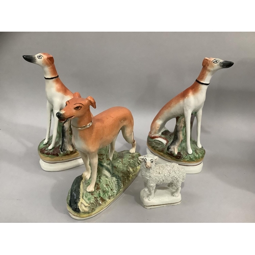 202 - A pair of 19th century Staffordshire greyhounds in seated positions 20.5cm high together with a late... 