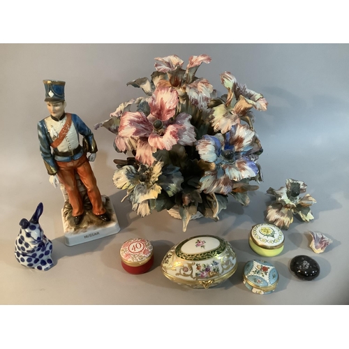 207 - A porcelain flower cluster in a basket, a continental figure of a Hussar bearing blue mark to base, ... 