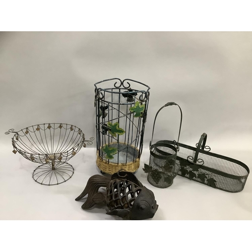 115 - A cast iron pierced fish shaped tea light holder, various wire baskets and plant holders