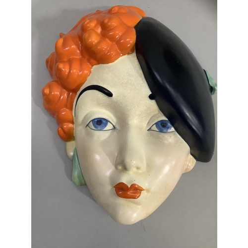 5 - A Beswick Art Deco pottery face mask of a girl wearing a black beret, printed mark and painted No: 7... 