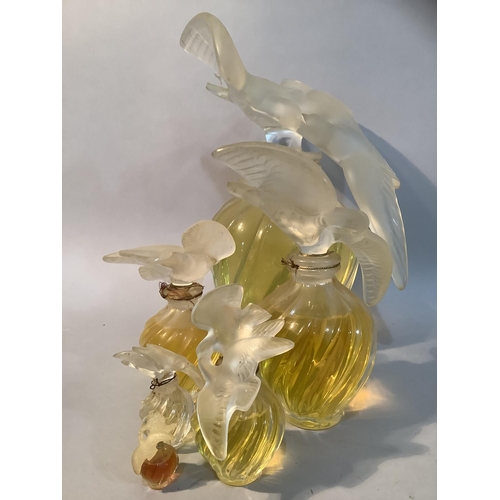 1 - A set of five Lalique factice perfume bottles for Nina Ricci L'Air du Temps of graduated size, the w... 