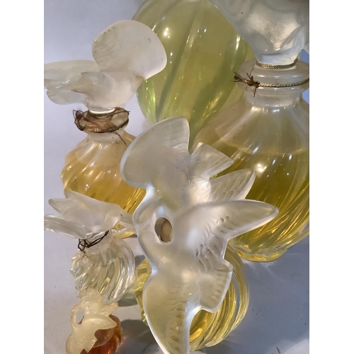 1 - A set of five Lalique factice perfume bottles for Nina Ricci L'Air du Temps of graduated size, the w... 