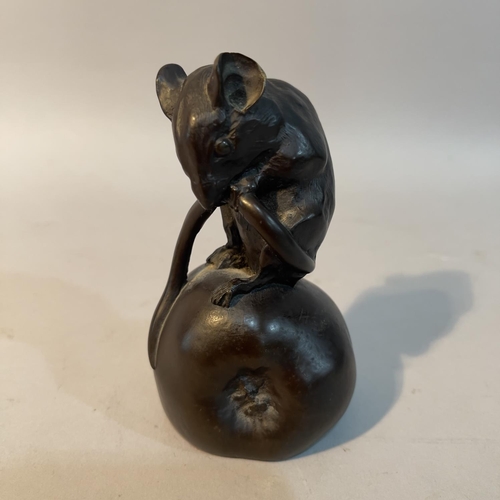 53 - A Heredites series bronze effect resin figure of a field mouse on an apple with it's tail tucked up,... 