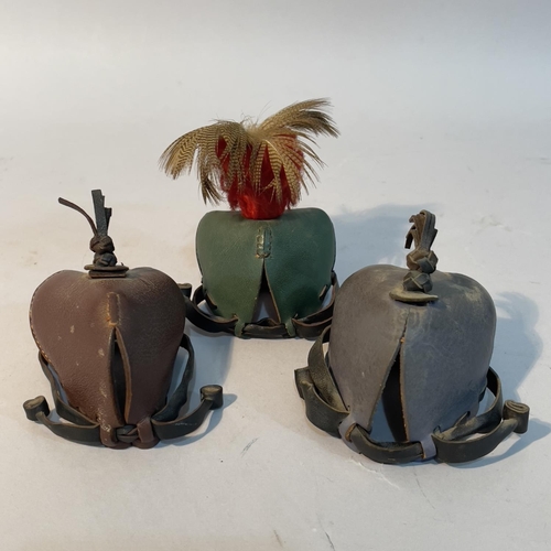 54 - Three leather falconry hoods, one with feather plume, 20th century (3)