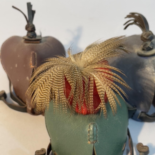 54 - Three leather falconry hoods, one with feather plume, 20th century (3)