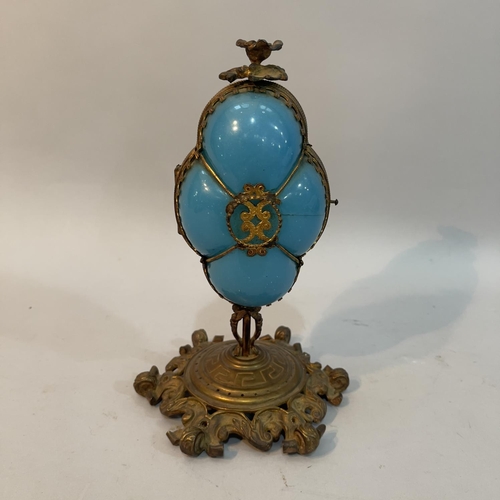 55 - A Victorian gilt metal mounted turquoise glass pedestal casket of quatrefoil outline, flower finial,... 