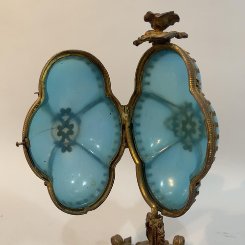 55 - A Victorian gilt metal mounted turquoise glass pedestal casket of quatrefoil outline, flower finial,... 