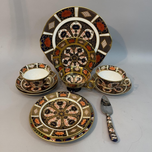 56 - A pair of Royal Crown Derby trios, cup, saucer and plate, pattern 1128, date code c1930/31, together... 