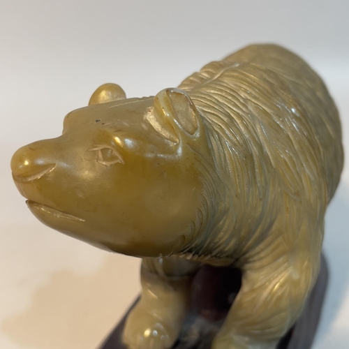 57 - A Chinese carved agate figure of a bear, on hardwood stand, 9.5cm high overall