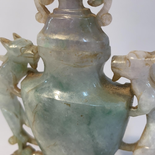 62 - A Chinese jade vase and cover, of urn outline with twin dragon handles, on hardwood stand, 14.5cm