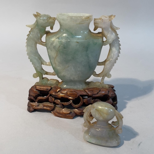 62 - A Chinese jade vase and cover, of urn outline with twin dragon handles, on hardwood stand, 14.5cm