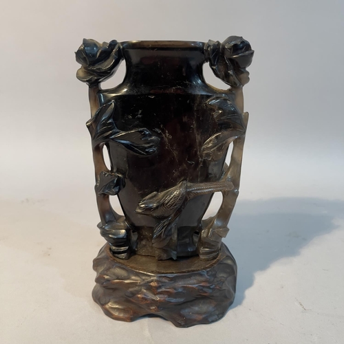 63 - A Chinese dark grey quartz vase carved in relief with flowering branches and bird, 13.5cm high with ... 