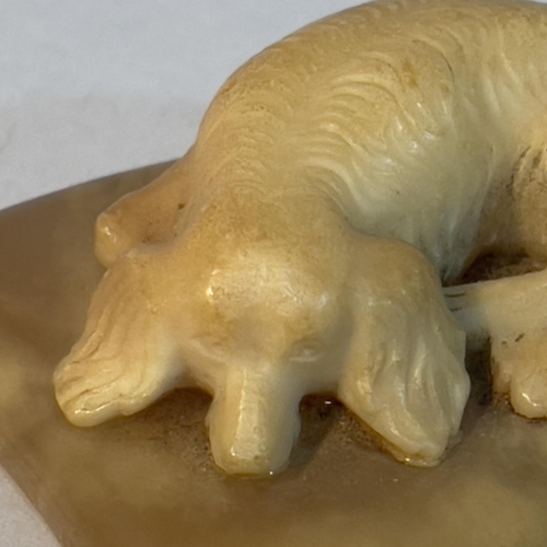 69 - A soapstone carving of a spaniel recumbent on a cushion, 6.5cm x 5cm x 2.5cm high