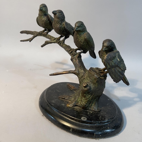 70 - A bronze group of sparrows perched on a branch, on an oval black marble plinth, 31cm wide x 20cm hig... 