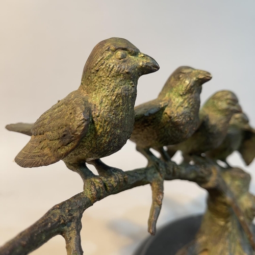 70 - A bronze group of sparrows perched on a branch, on an oval black marble plinth, 31cm wide x 20cm hig... 