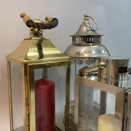 201 - Two chrome storm lanterns, a brass example and another