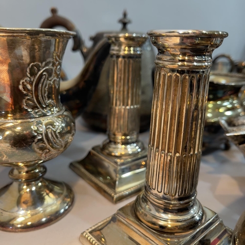 236 - A silver plate on copper tea service, another with moulded handles on paw feet, a pair of reeded can... 