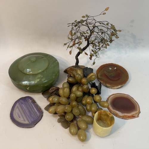 237 - Two soapstone bundles of grapes, wire work model of a tree with green glass leaves and on rock base,... 