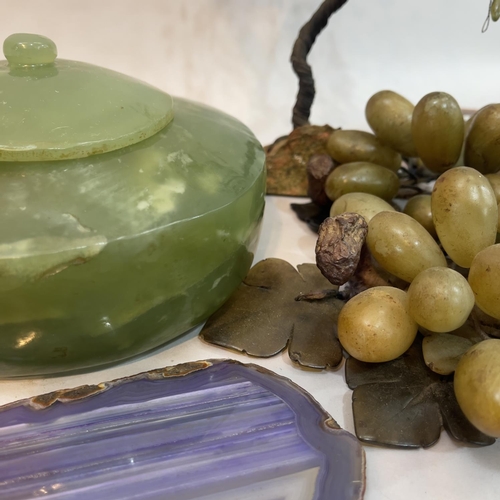 237 - Two soapstone bundles of grapes, wire work model of a tree with green glass leaves and on rock base,... 