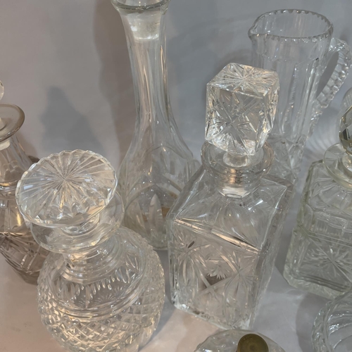 206 - Cut glass water jug, pair of spirit decanters and five further decanters, powder bowl and cover and ... 