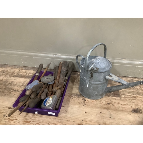 119 - A quantity of tools and a tin watering can