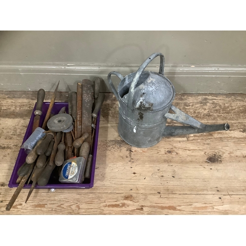 119 - A quantity of tools and a tin watering can