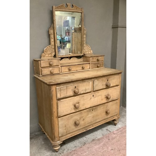 140 - A pine dressing table and drawers having two short above three long drawers below a dressing mirror ... 