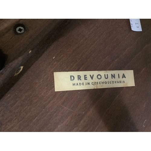 126 - A set of four spindle back Drevounia chairs, some with labels to base