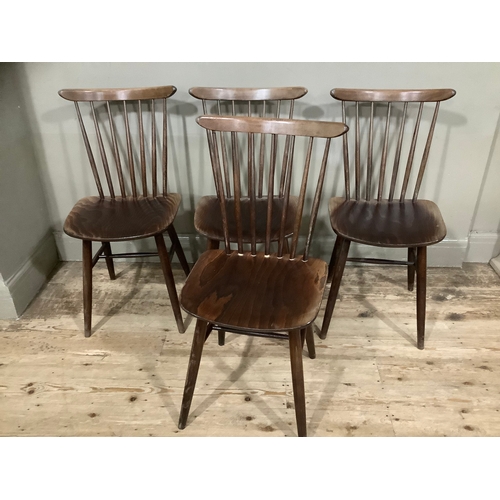 126 - A set of four spindle back Drevounia chairs, some with labels to base