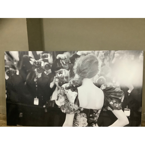 127 - A black and white print on canvas of a woman at a premiere in a floral dress in front of press, 130c... 